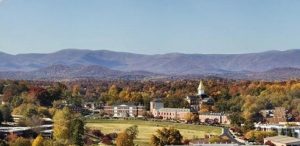 Panorama of the University of North Georgia, with trees and mountain ranges in the background