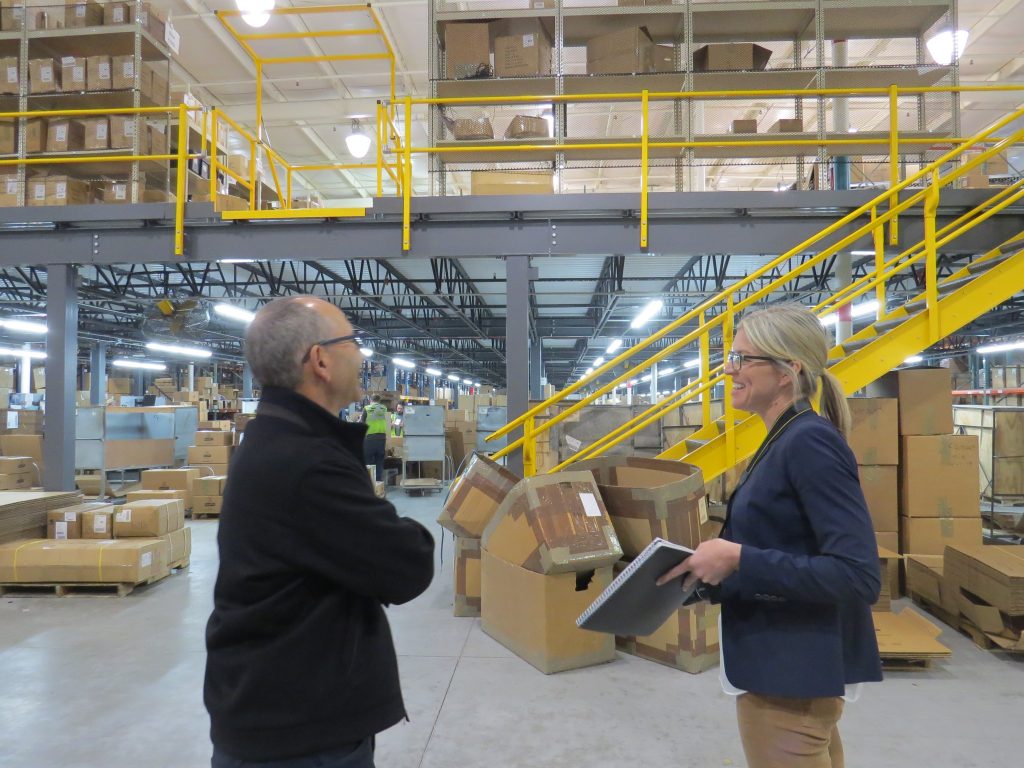 Image of two people surrounded by boxes.