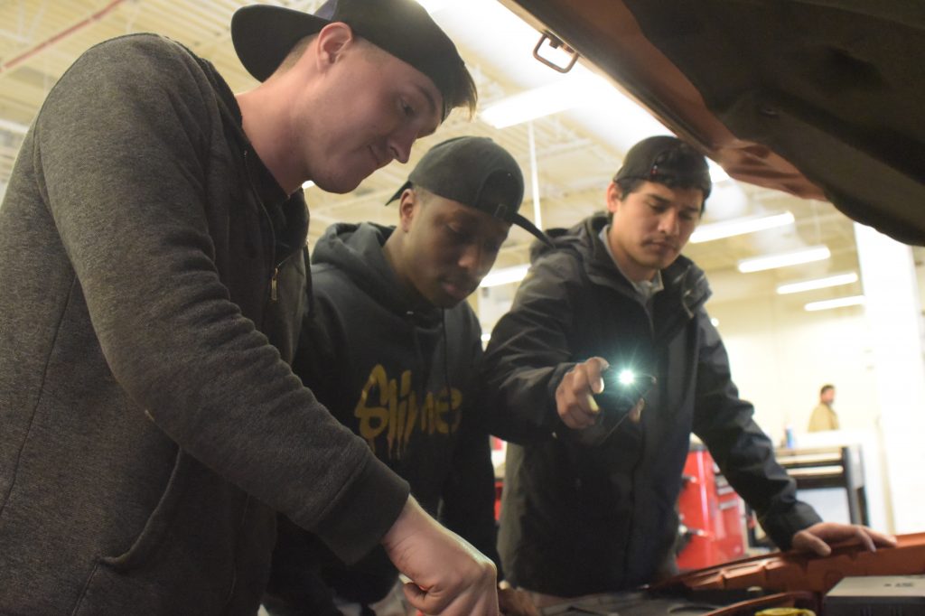 Lanier Technical College Students looking into a car